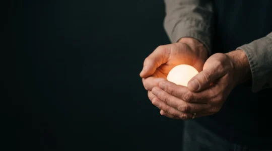 A parent's protective hand cupped gently around a soft glowing light, symbolizing guardianship of a child's online world